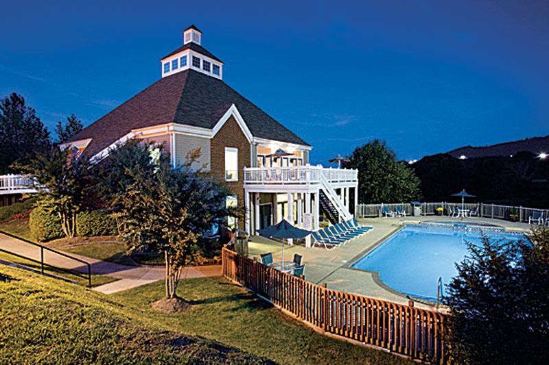 a house with a swimming pool in front of it