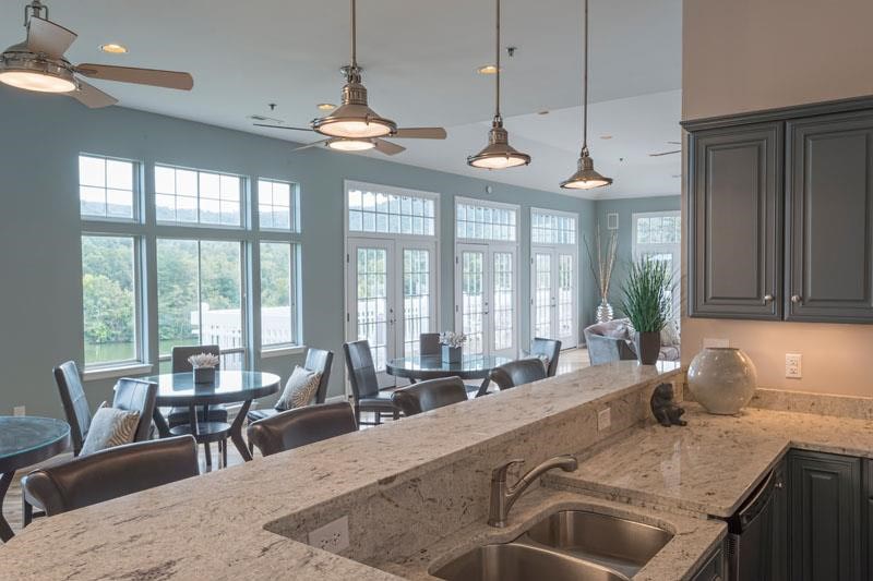 a kitchen with a sink and a table with chairs