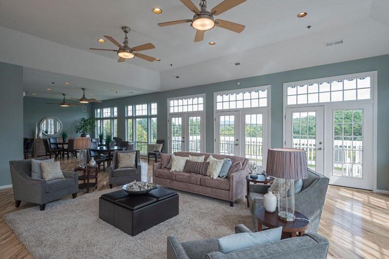 a large living room with couches and chairs