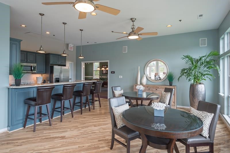 a dining room and kitchen with a table and chairs