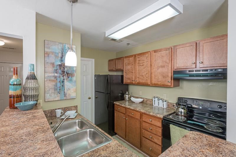 a kitchen with granite counter tops and a sink