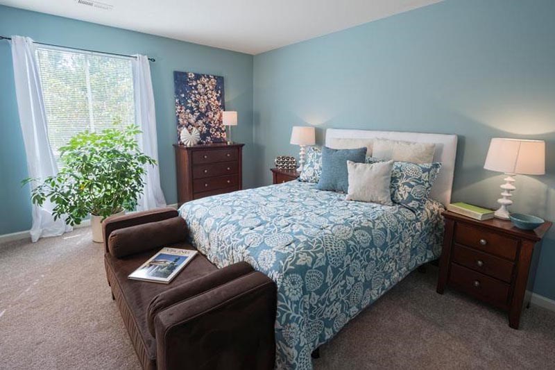 a bedroom with a bed and a couch