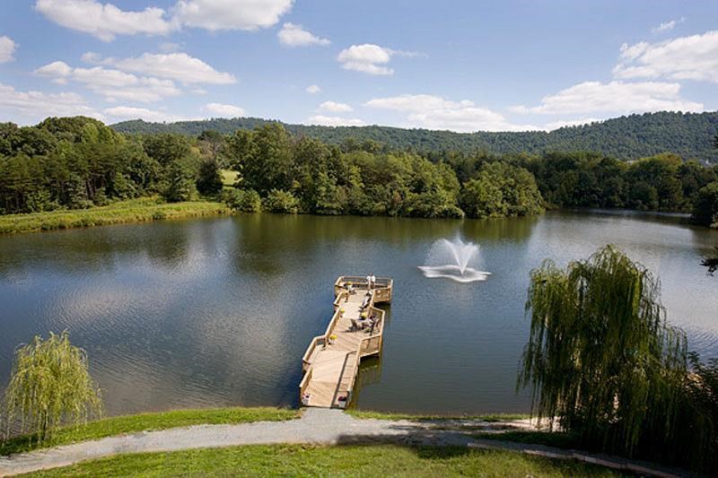 a lake with a boat and a water fountain