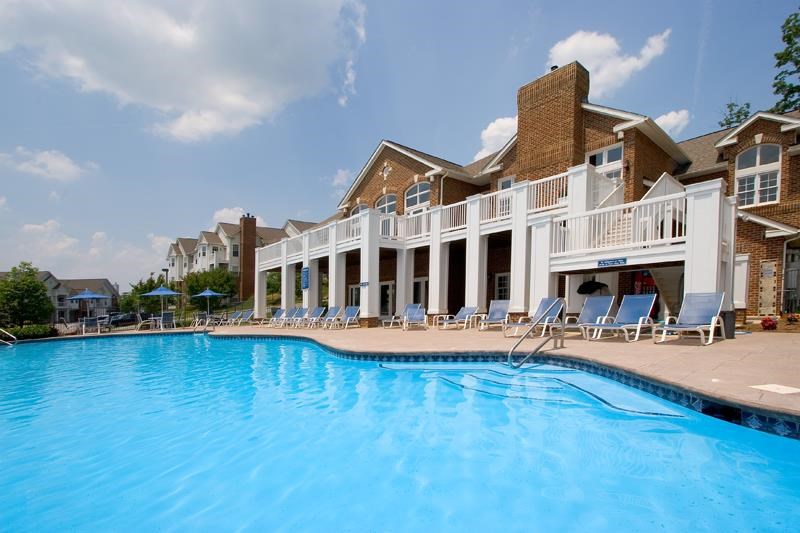 a large swimming pool in front of a hotel