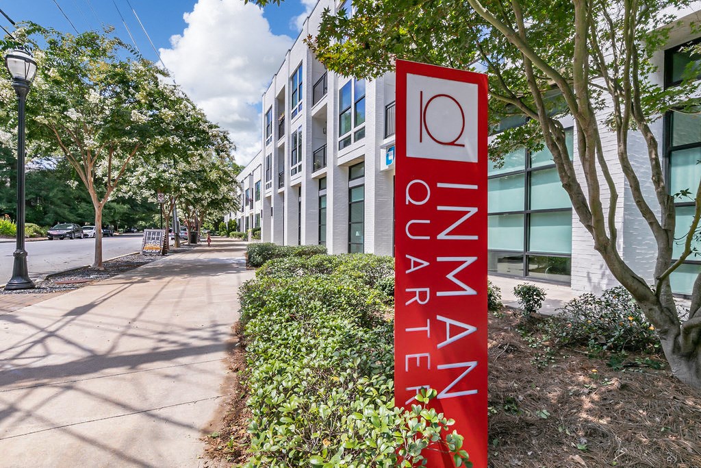 a sign in front of a building with a no parking sign