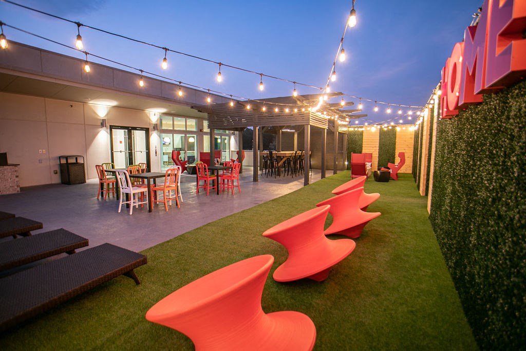 a lounge area with chairs and tables and lights