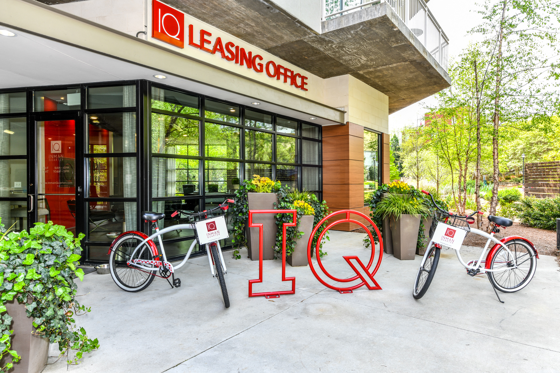 two bikes parked outside of a leasing office