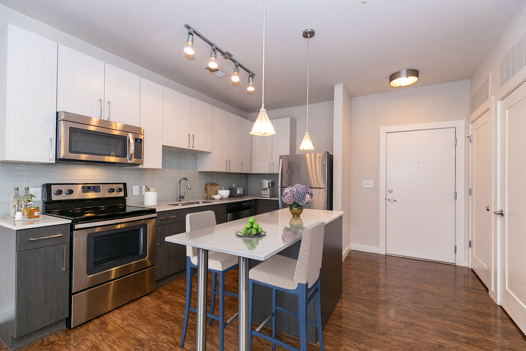 a kitchen with stainless steel appliances and a white counter top