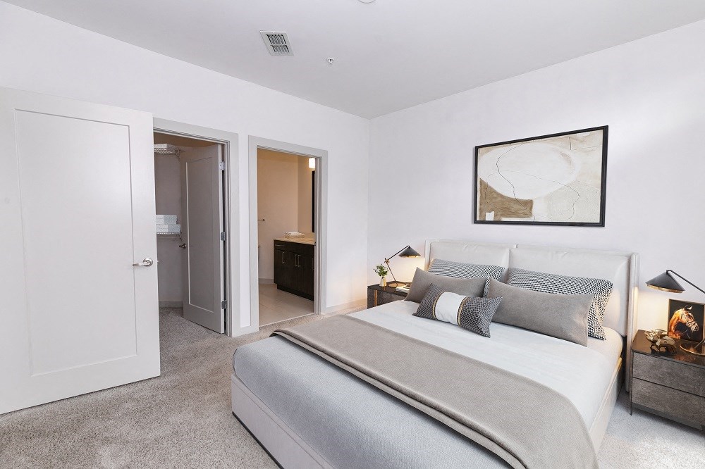 a bedroom with a bed and a door to a bathroom