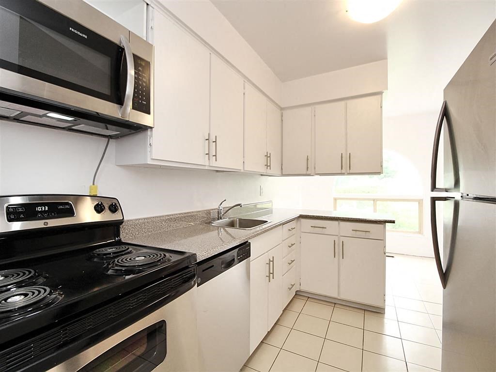 a kitchen with a stove and a sink and a refrigerator