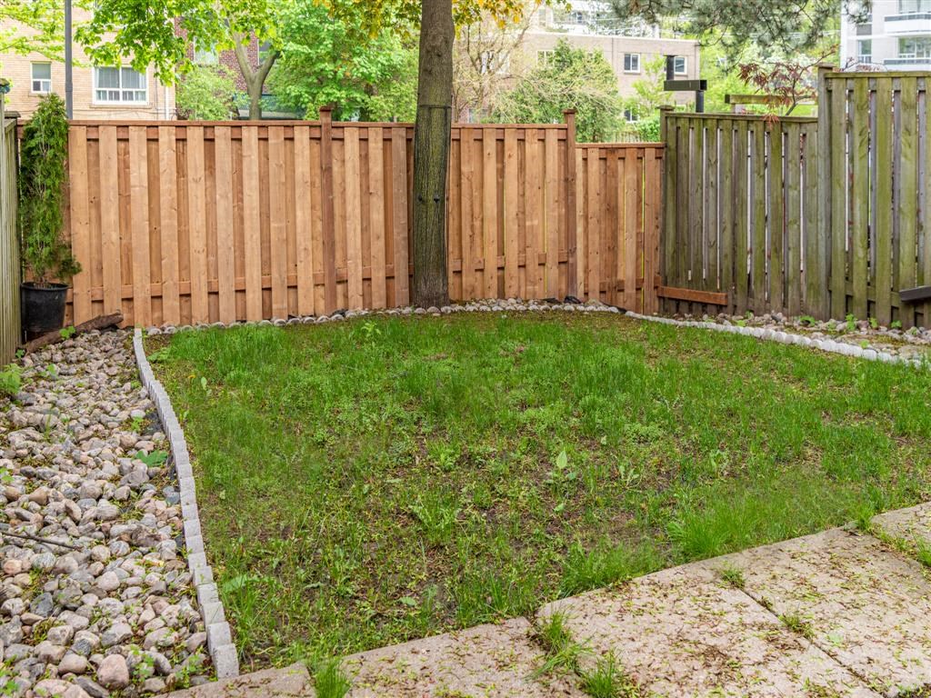 a wooden fence in a backyard with grass