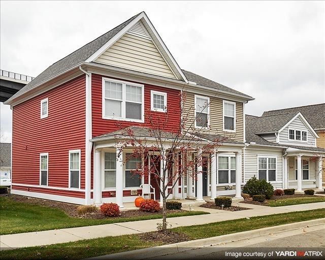 a red house on the side of a street