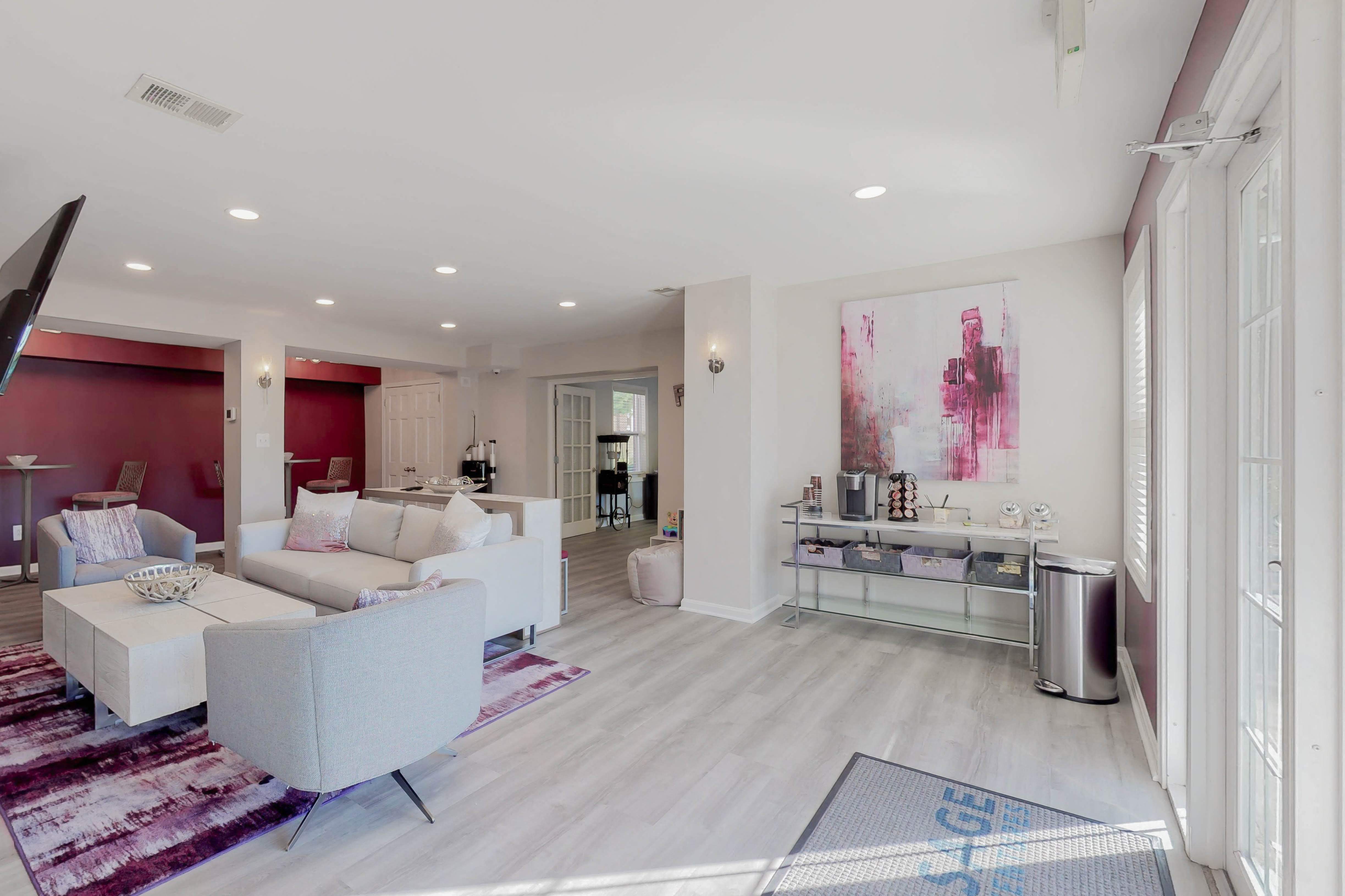 a living room with white couches and a rug