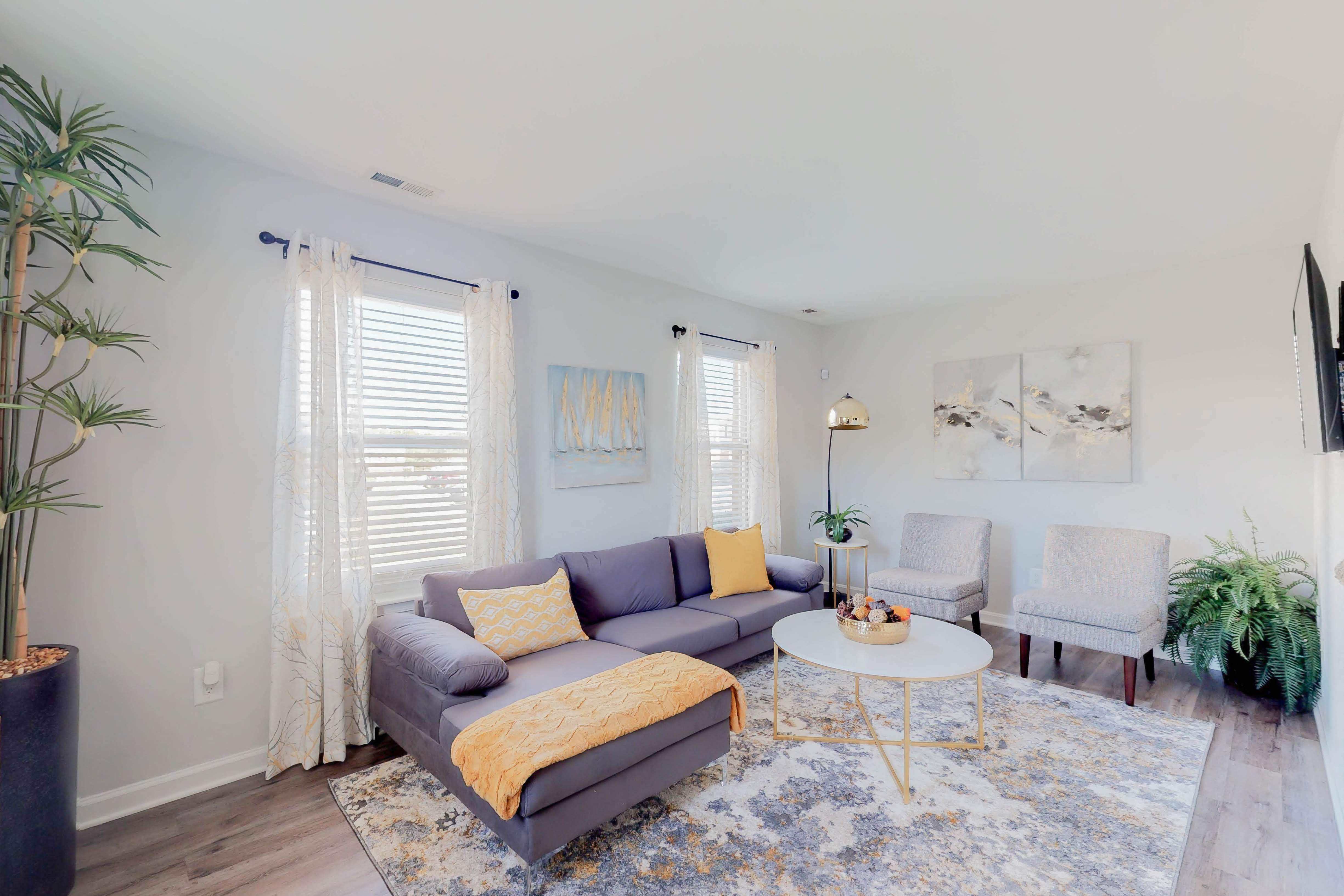 a living room with a couch and two chairs