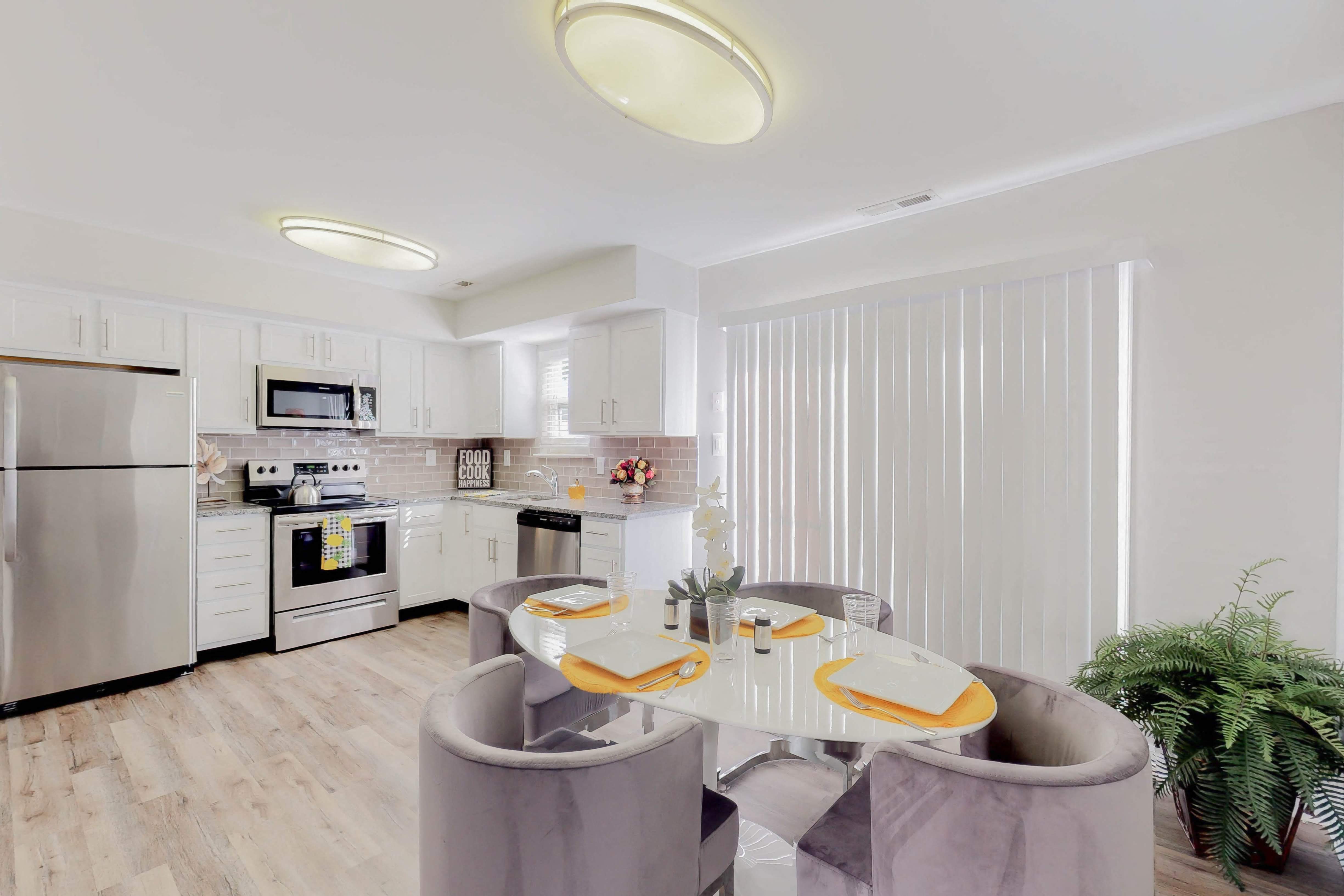 a kitchen and dining room with a table and chairs