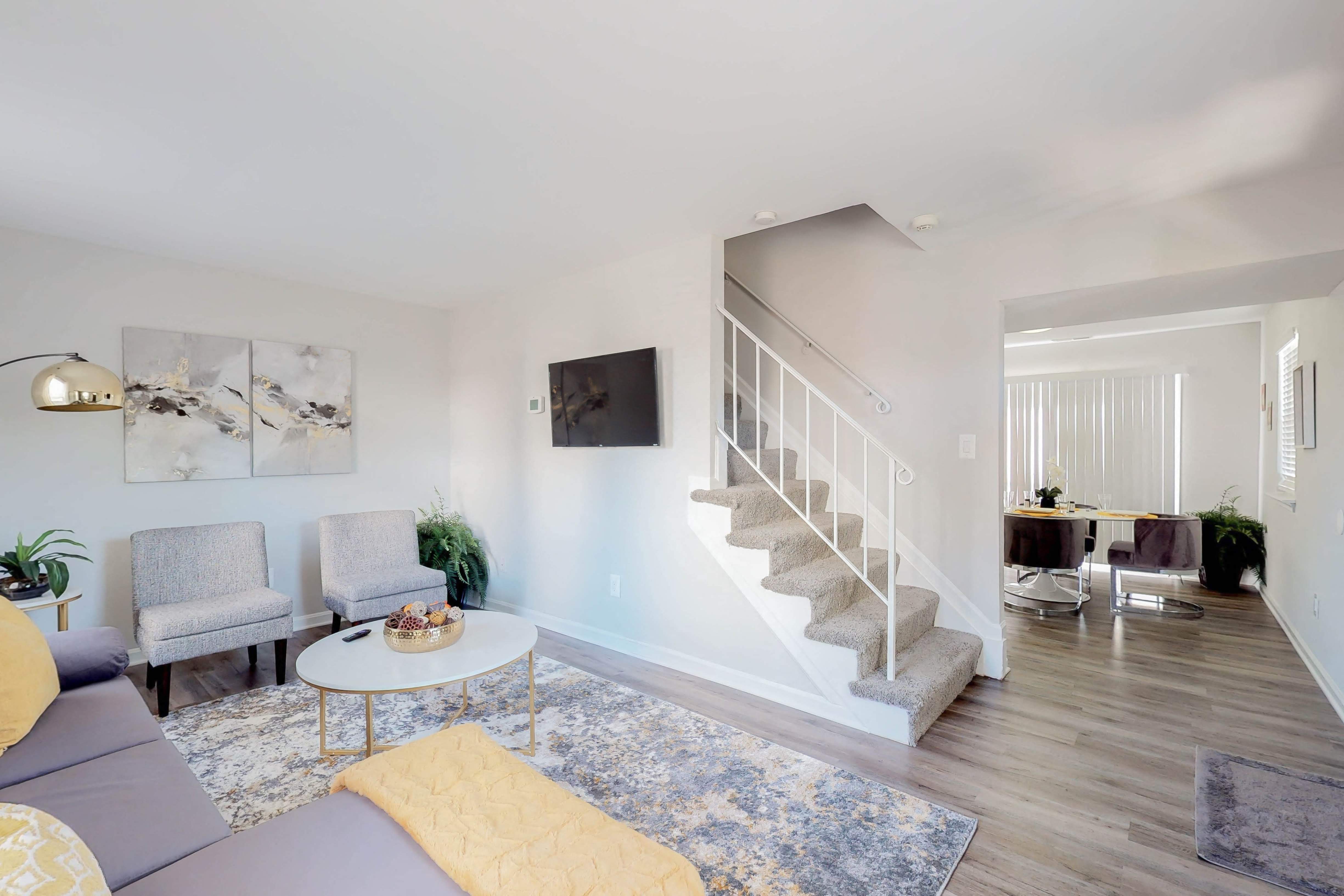 a living room with a staircase and a couch