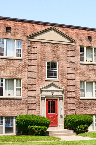 a red brick building with a red door