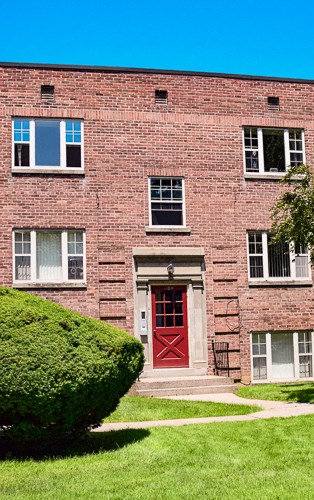 a red brick building with a red door