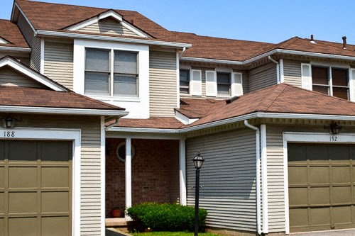 a row of houses with garages in front of them