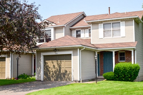 a house with a garage door in front of it