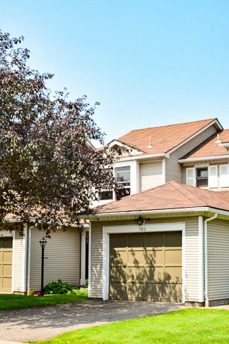 a house with a garage door in front of it