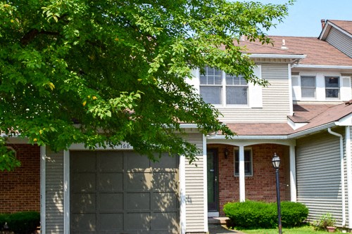 a house with a garage door in front of it