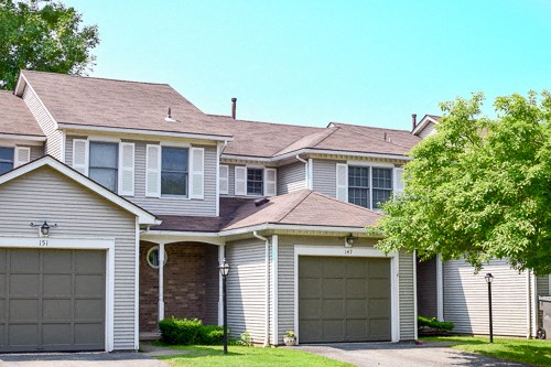 a house with two garages in front of it