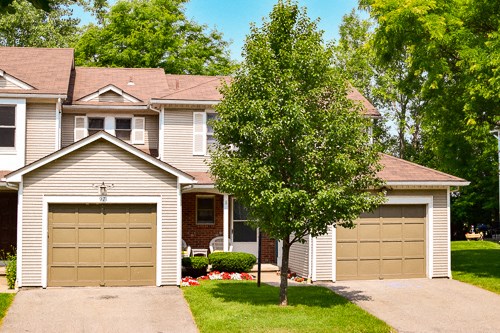 a house with two garage doors in front of it