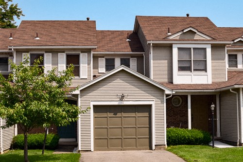 a house with a garage door in front of it