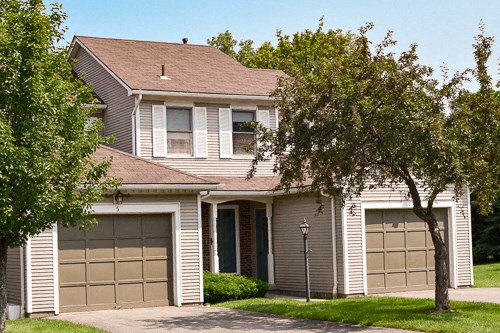 a white house with two garage doors