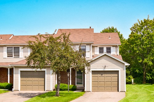 a suburban house with two garage doors