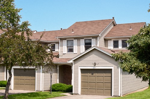 a white house with two garage doors