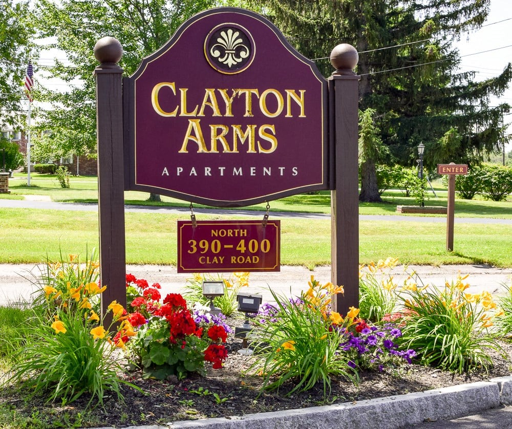 a sign in front of a garden