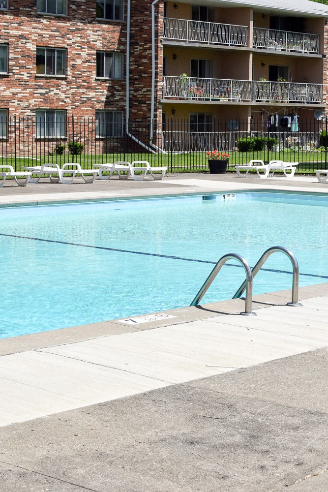 a swimming pool in front of an apartment building