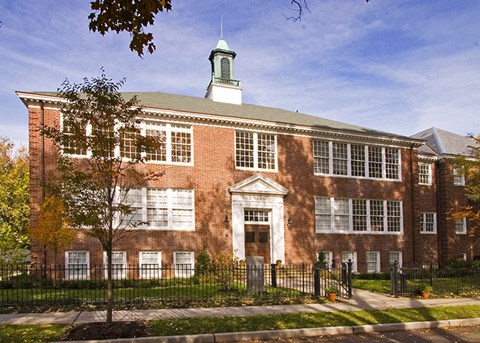 a large brick building with a fence in front of it
