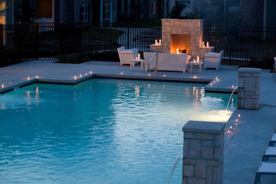 a swimming pool with a fireplace in the background at Plantation Crossing, Lafayette