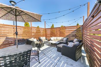 Dining Area Covered By Umbrella at Aventura at Forest Park, Missouri, 63110