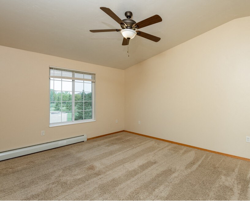 Spacious Bedroom with Ceiling Fan and Large Window