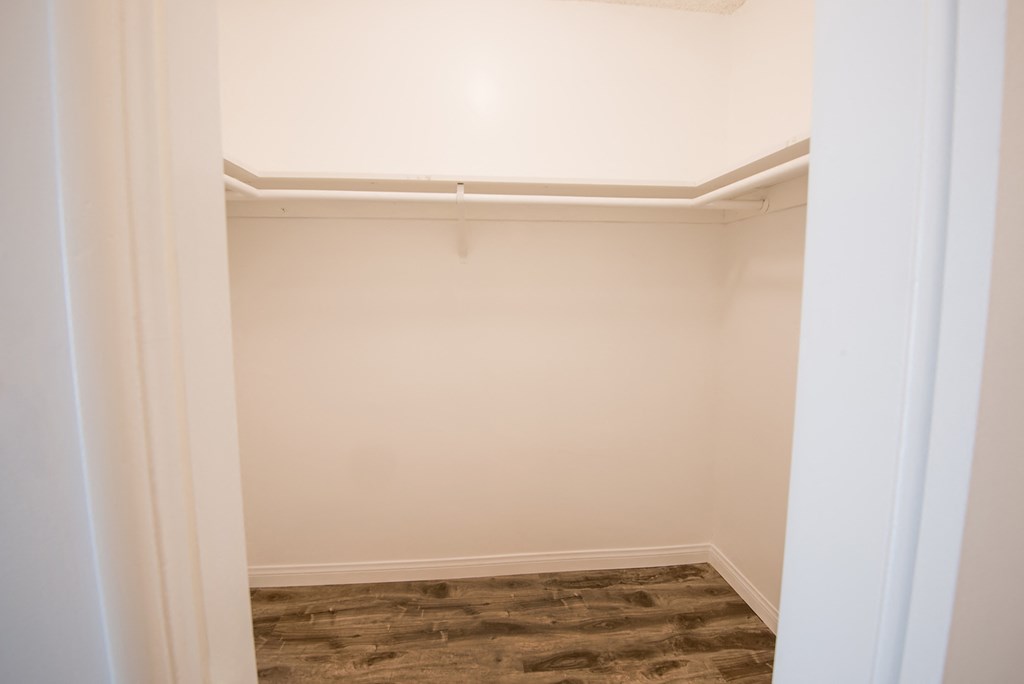 a room with a white wall and a closet