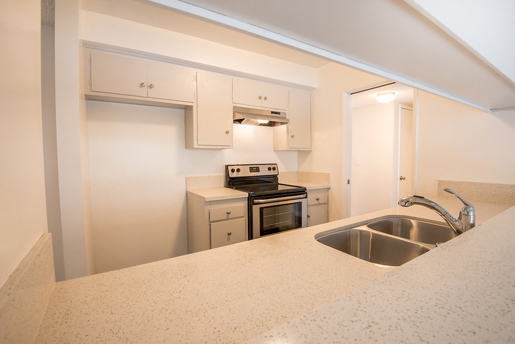 a kitchen with white cabinets and a sink