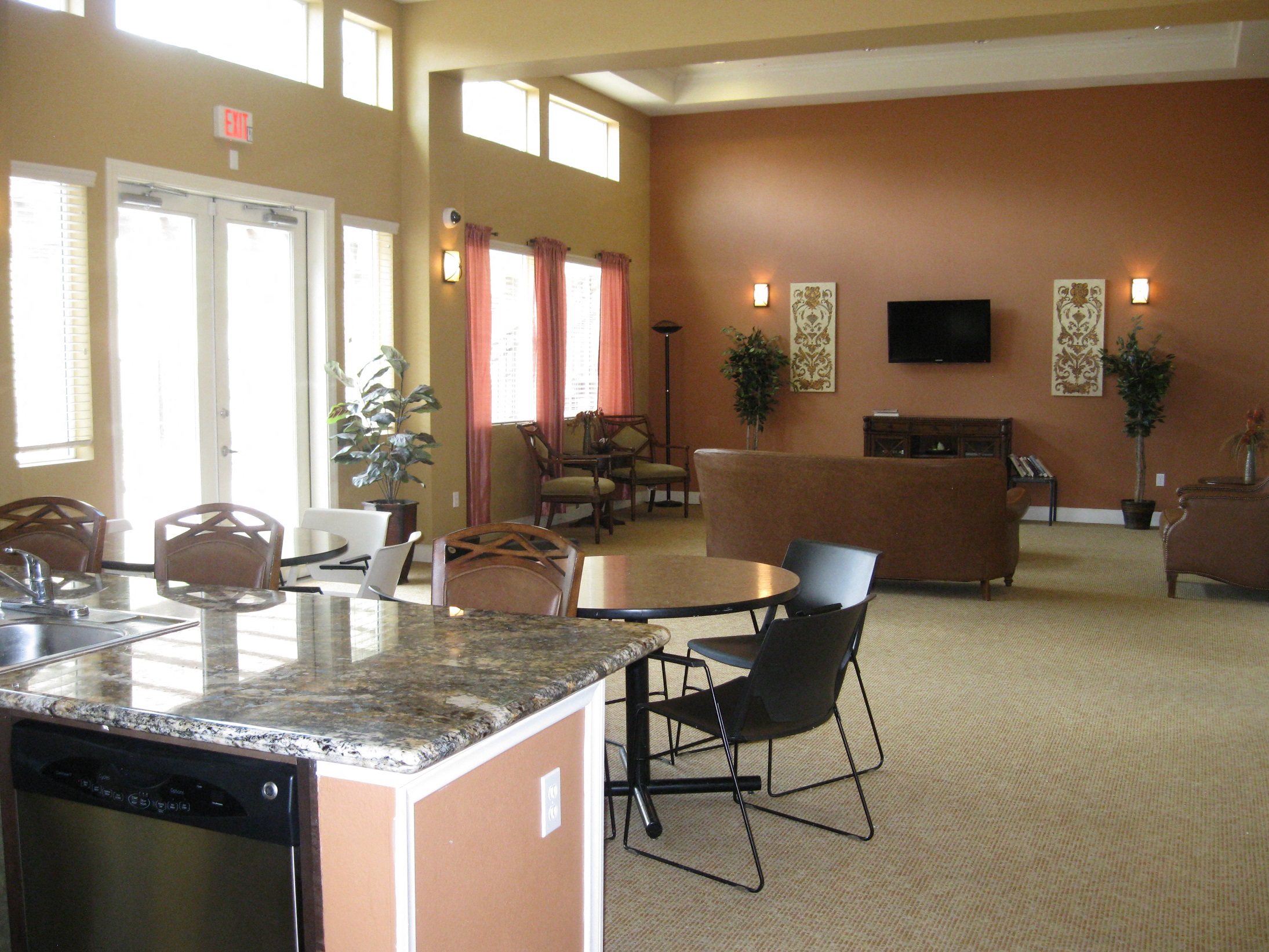 a living room with a kitchen and a table and chairs