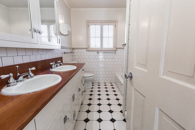 a bathroom with two sinks and a shower and a toilet