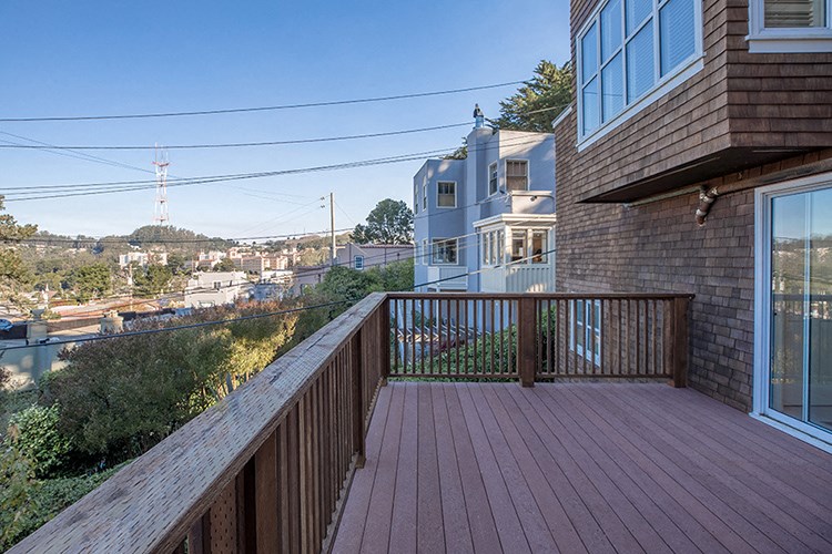 a view of the city from the balcony of a home
