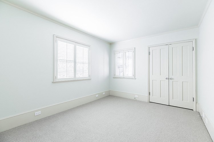 an empty room with white walls and a white door and window