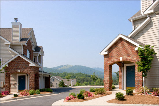 a street of houses with mountains in the background