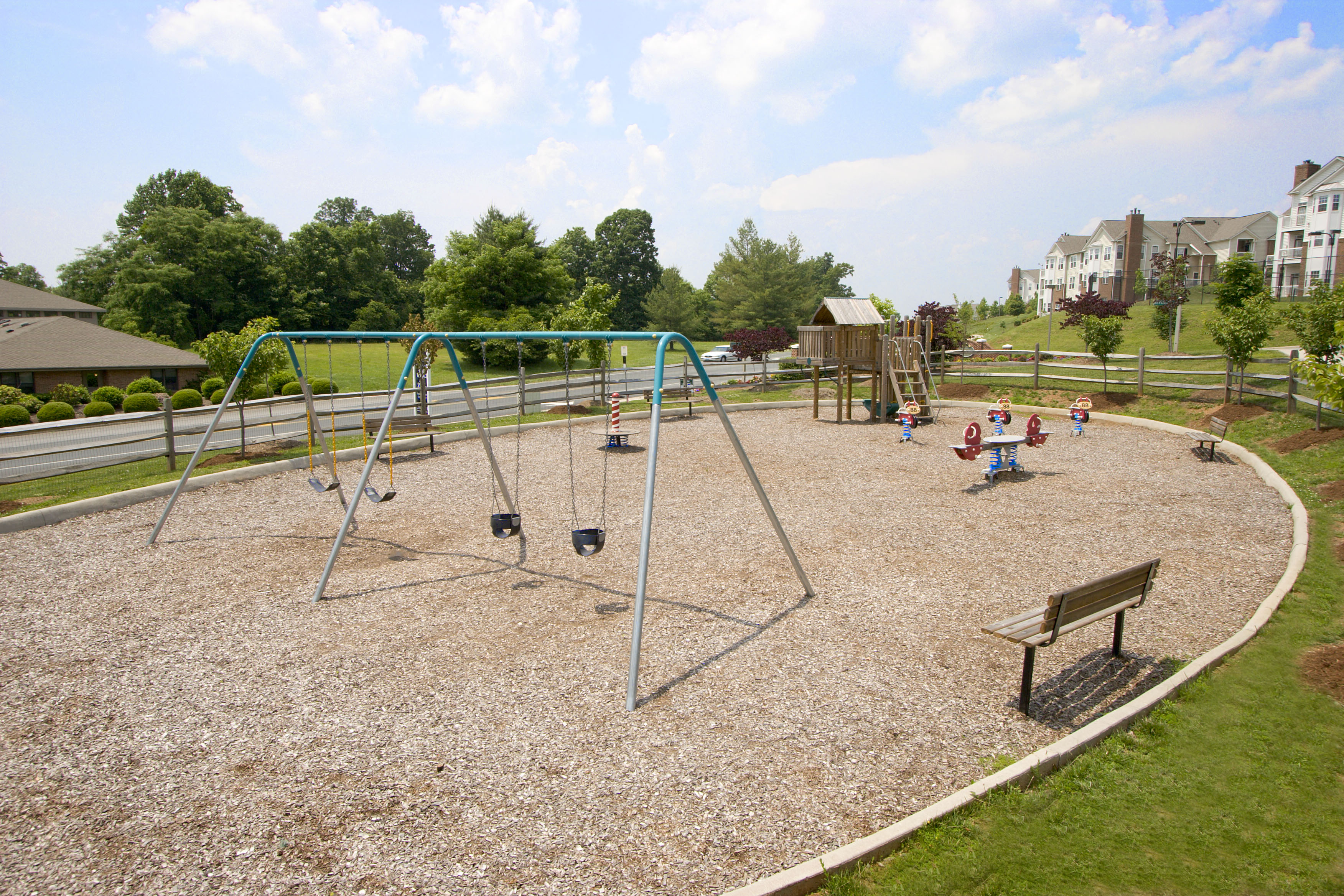 children playing on a swing set in a park