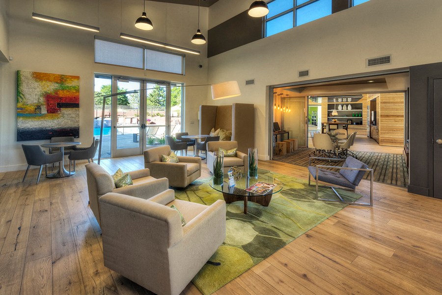 a living room with couches and chairs and a rug