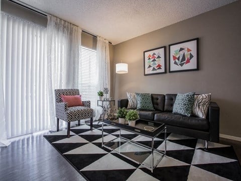 a living room with a checkered rug and a couch