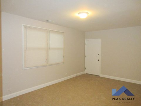 the living room of a home with a window and a door