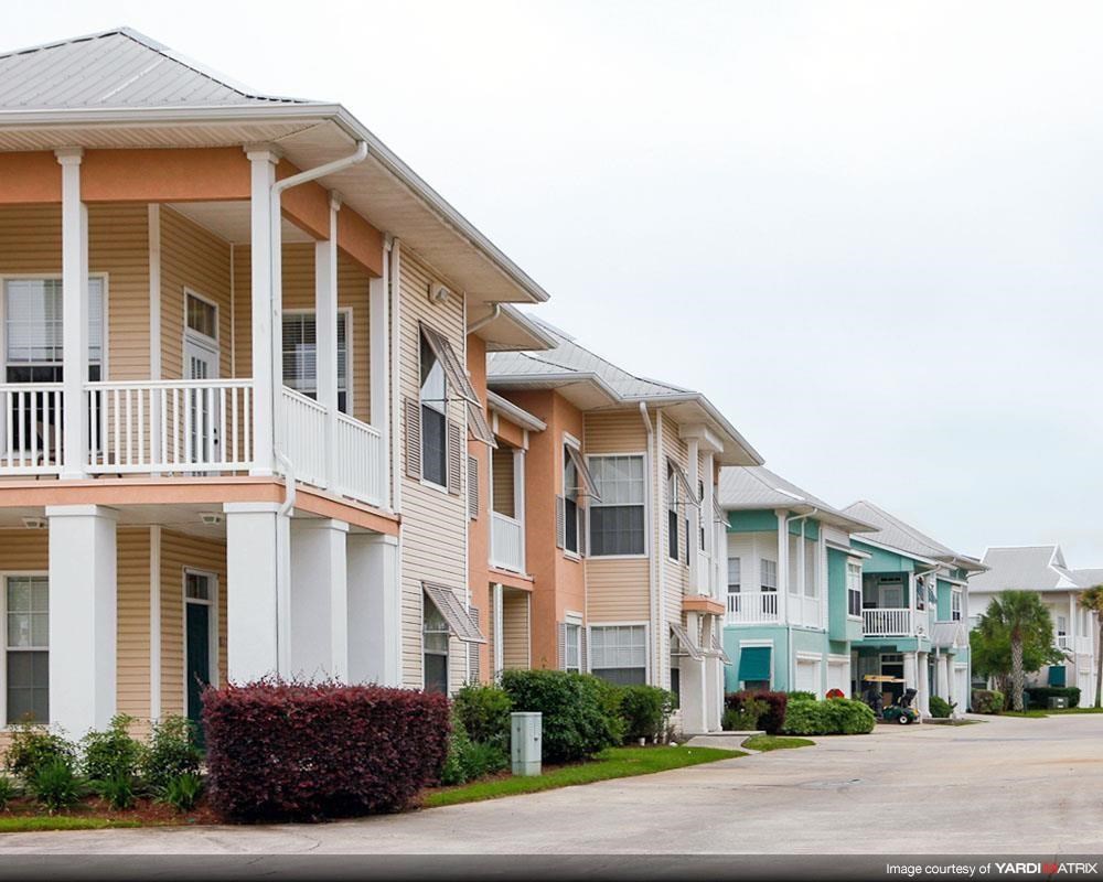 a row of houses with balconies on the side of a street